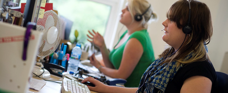 Figure 8. Giving call center workers a degree of autonomy boosts both
                                their job satisfaction and the quality of the users’ experience.Source: "Call
                            Centre" by The Open University (OU) is licensed under CC BY-NC-ND 2.0. 