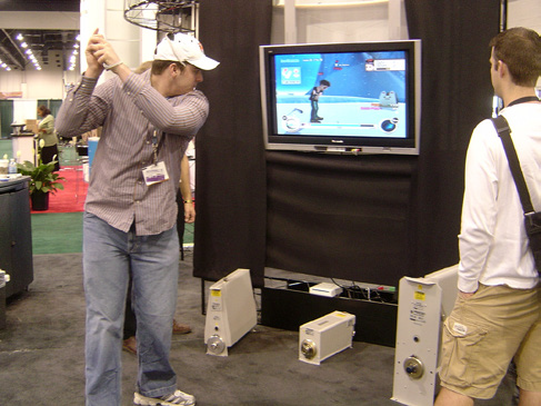 Figure 2. The Nintendo Wii changed perceptions of gaming with its active interface.Source: NAB 2007: Tom Playing Wii. by chrismetcalfTV is licensed under CC BY 2.0.